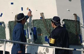 Coast guard staff examine damaged patrol vessel in Kagoshima